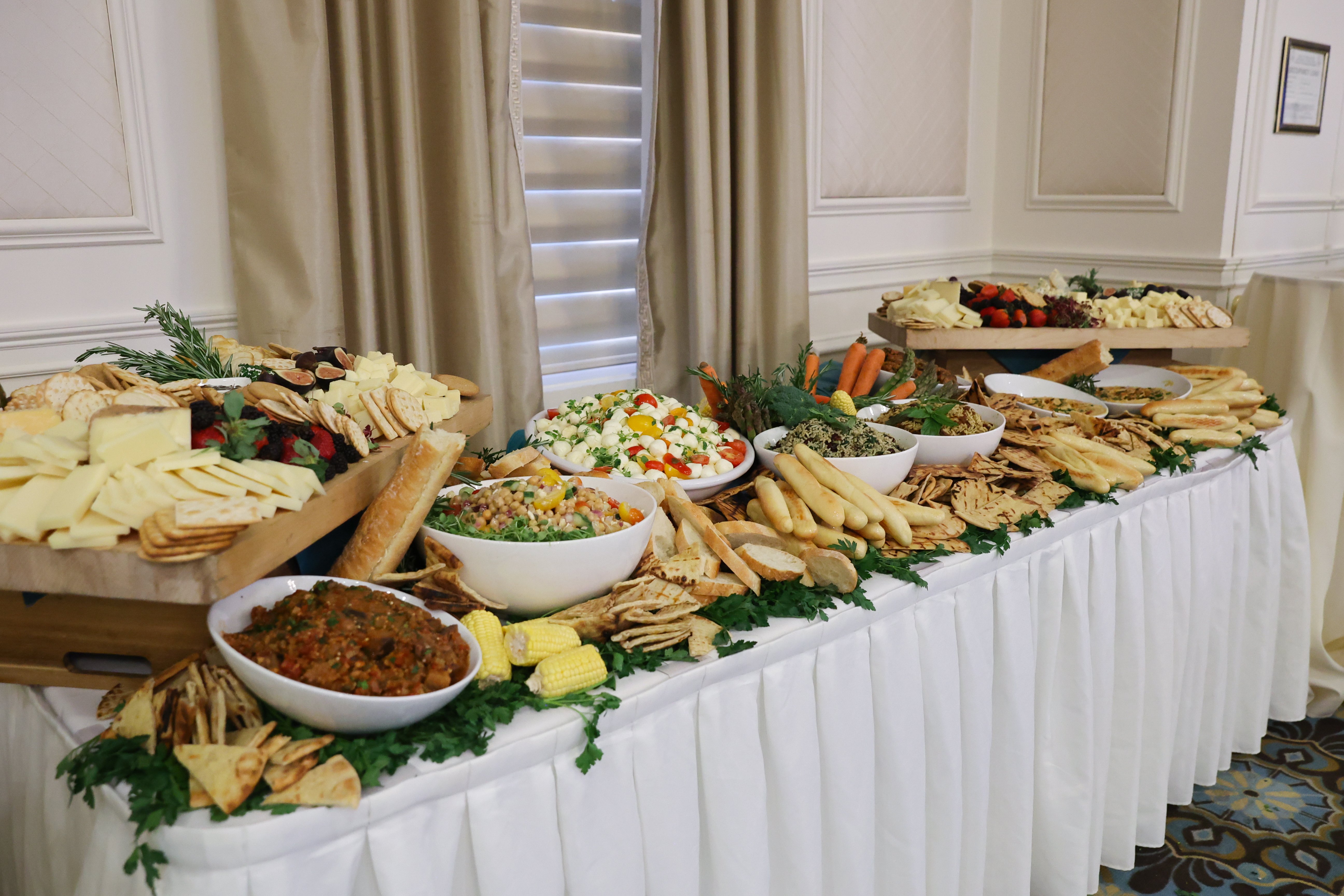 An elegant catered buffet with trays of appetizers and drinks
