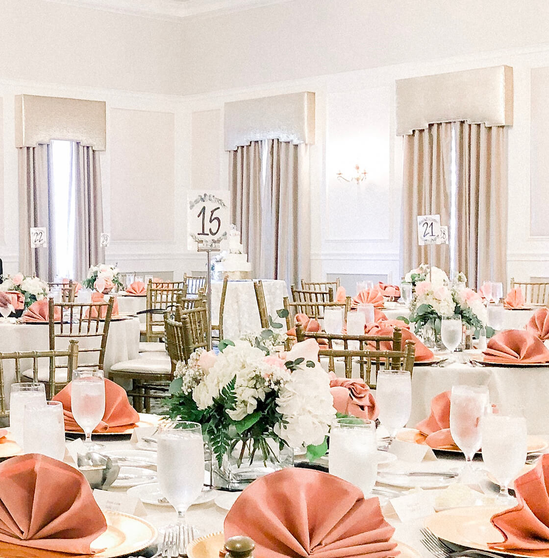 The Great Oak Ballroom set with round tables and a wood dance floor for a wedding reception
